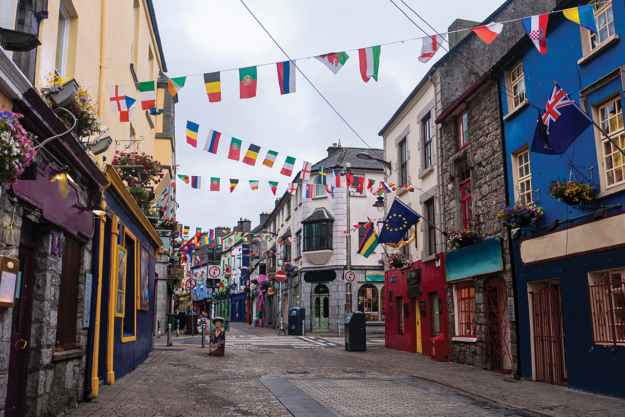 Cobblestone street with small hotels, shops, restaurants and bars.